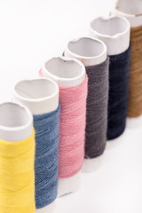Colorful threads on the white background