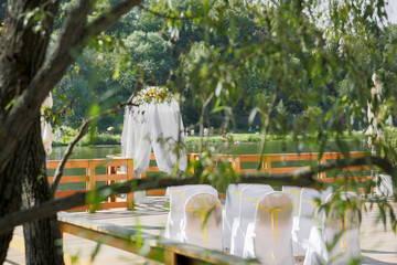 A view from green tree branches on a wedding altar standing abov