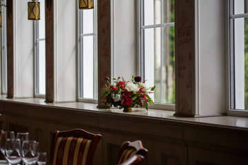 Fototapeta na wymiar Interior decor. Long white windowsill is beautified with a littl