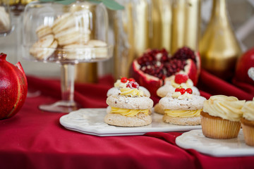 White pastry with cream stands on a white serving dish on a red