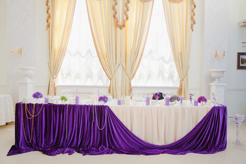 Gorgeous design of newlyweds table in restaurant decorated with