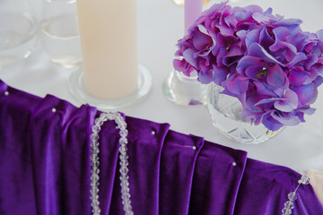 Crystals decorate a silk cloth put on the dinner table