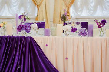Festive dinner table arranged in violet and beig colors