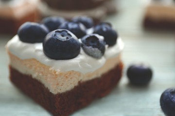 Tasty cake with blueberries on table, closeup