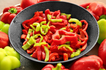 Fresh peppers on black plate, closeup