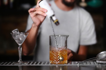 Barman preparing cocktail on bar counter