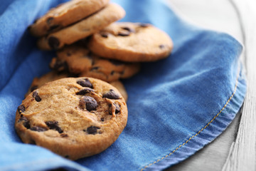 Fresh oat biscuits with chocolate on napkin, closeup
