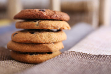 Fresh oat biscuits with chocolate on napkin, closeup