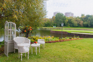Lake shore decorated with flowers and garden furniture