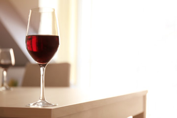Glass of red wine on table in restaurant