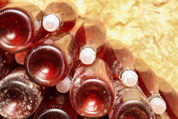 Obraz na płótnie Canvas Bottles with wine in cellar, closeup