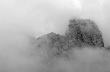 Mountain top on Marmolada glacier with clouds