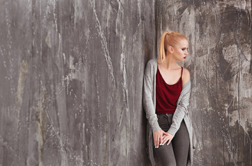 Naklejka premium Pretty young blonde woman in casual clothes against grunge background