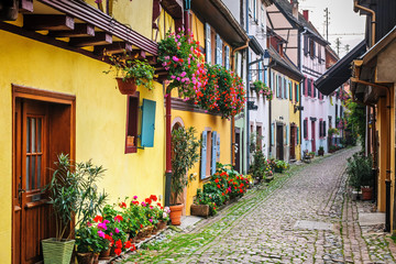 Fototapeta na wymiar Half-timbered houses on a narrow street in Eguisheim, Alsace, France