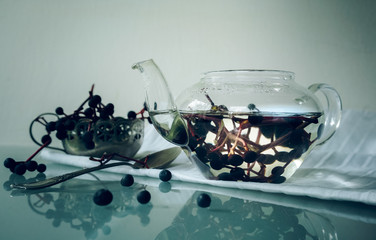 still life. bunches of wild grapes in a glass pot. close-up.