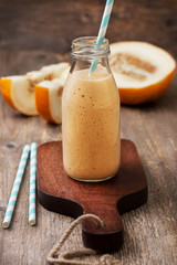 melon  smoothie in a glass bottle
