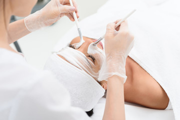 Obraz na płótnie Canvas Professional cosmetologist making facial treatment