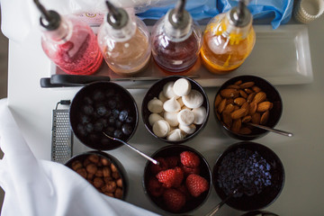 Berries and nuts lie in black bowls