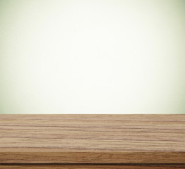 Empty wooden table over blue cement wall  background