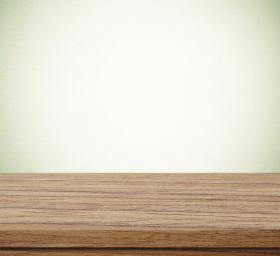 Empty wooden table over blue cement wall  background