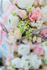 Tiny green buds hang from a basket with flowers
