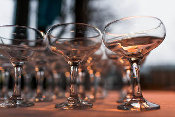 Cocktail glasses stand empty on the table