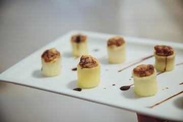 Brown stuffing looks tasty being put in white paste