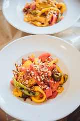 Salad made of sea products and vegetables in a white plate