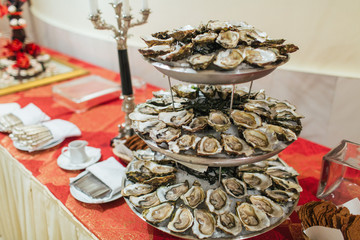 Tired tray with mussels stands on the buffet