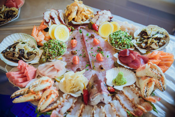Fototapeta na wymiar Tasty salted sea products lie together with souces on a serving