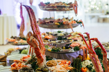 Red squid clasw hang over a table full of marine products