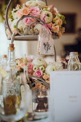 A package with cookie hangs from the steel stand with roses