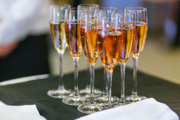 Champagne flutes stand on the black cloth