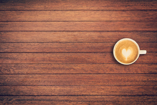 Latte coffee on table wood background with space