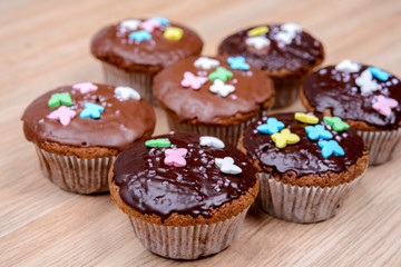 chocolate muffins on wooden ground