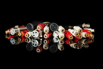 Many different connectors with reflection, isolated on black background.