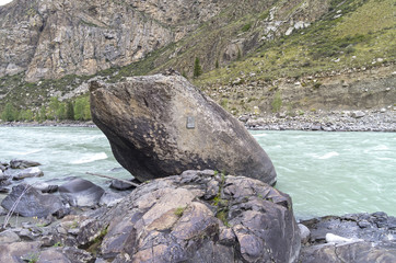 A stone with a plaque in memory of the deceased tourist. Altai M