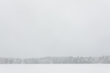 Naklejka premium Blizzard winter landscape at frozen lake