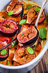 Baked figs with thyme, mint, vanilla pods in orange syrup