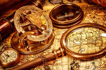 Fototapeta na wymiar Vintage magnifying glass lies on an ancient world map