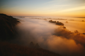 Misty sunrise on the river and on the forest