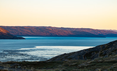 Fototapeta na wymiar The sunset in Greenland, harbor of Kangerlussuaq
