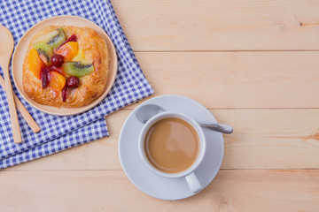 fruit pie and a cup of coffee on wood table