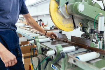 Manual worker assembling PVC doors and windows. Manufacturing jobs. Factory for aluminum and PVC windows and doors production. Selective focus. 