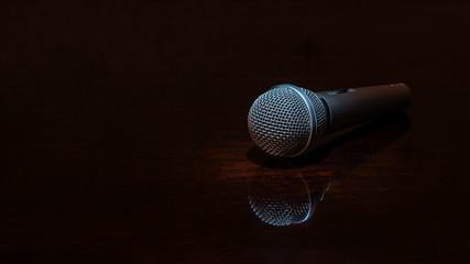 Vocal microphone on dark polished surface