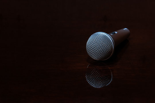 Vocal microphone on dark polished surface