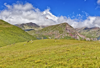 Beautiful mountain landscape and green hills, bright blue sky. N