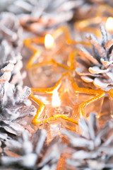 Christmas. Christmas card with glowing small candle and fir cone