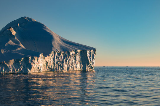 The sunset with icebergs on the ocean in Ilulissat, Greenland