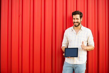 smiling man with tablet on background